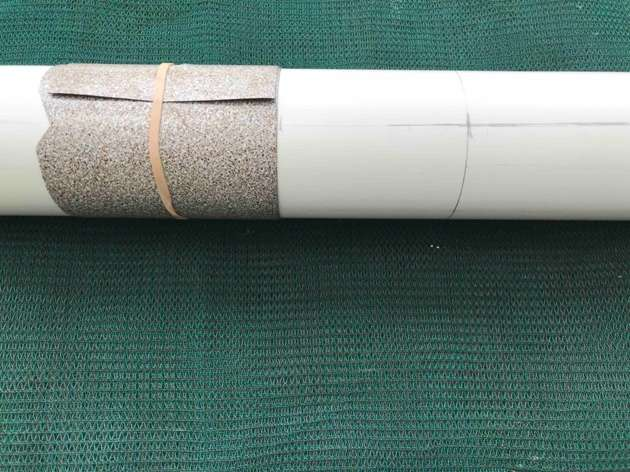 A segment of pipe being marked with some lino