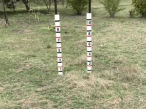 A pair of grass measuring posts in a field