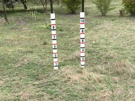 A pair of grass measuring posts in a field